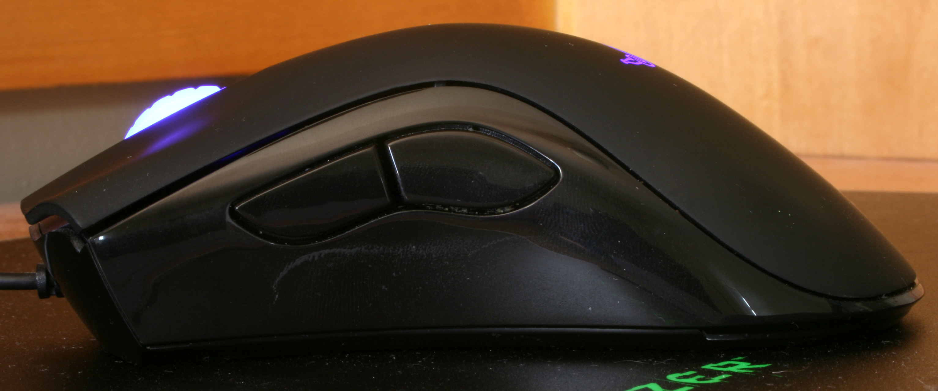 A Razer DeathAdder mouse, with hand salsa on the plastic side.