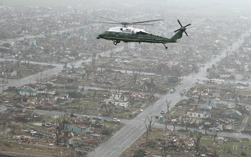 President George W. Bush flies over the destroyed town of Greensburg, Kansas following a violent EF5 tornado in 2007|alt=A helicopter flying over destroyed buildings.