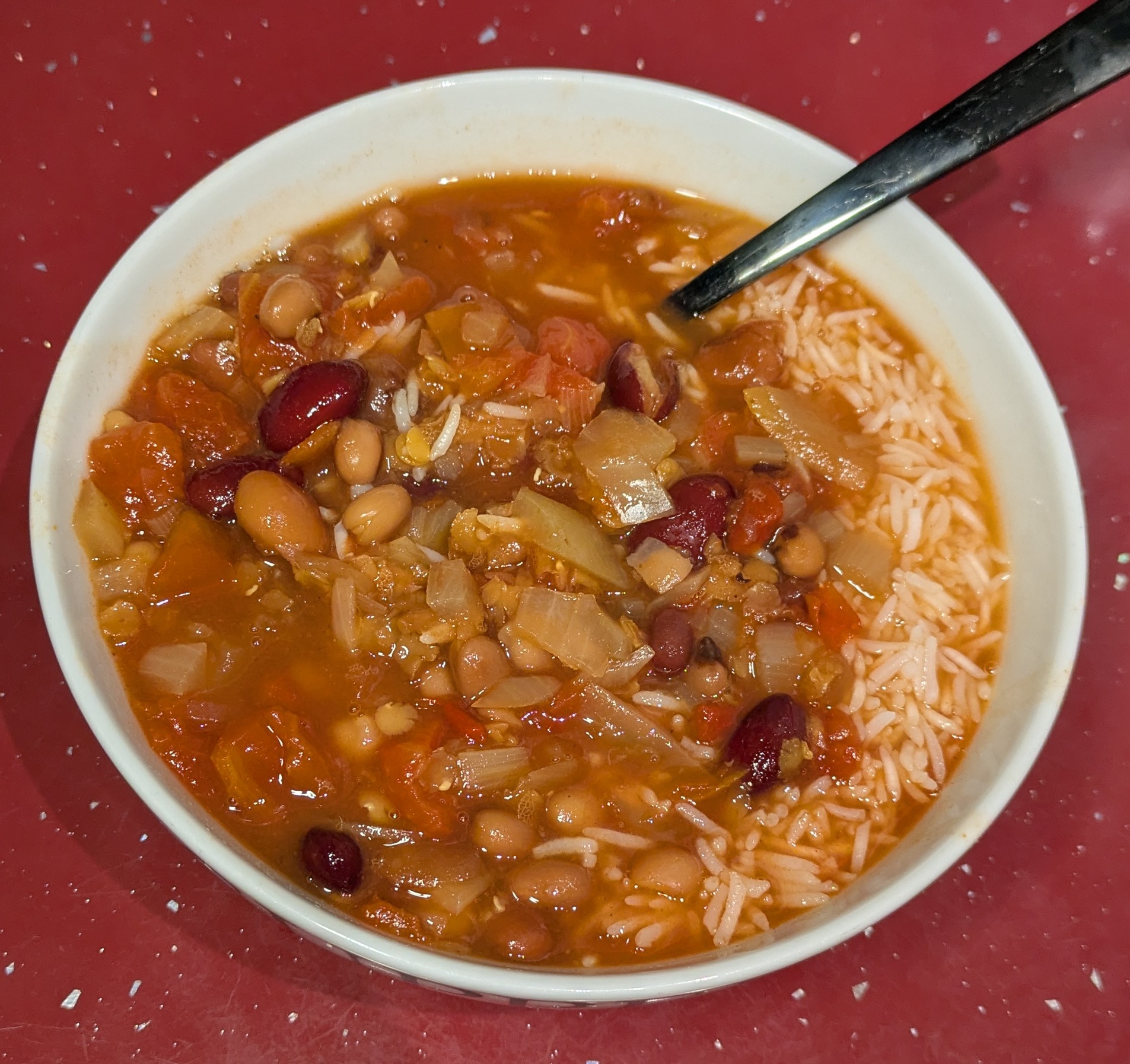 A photo of bean soup served with rice