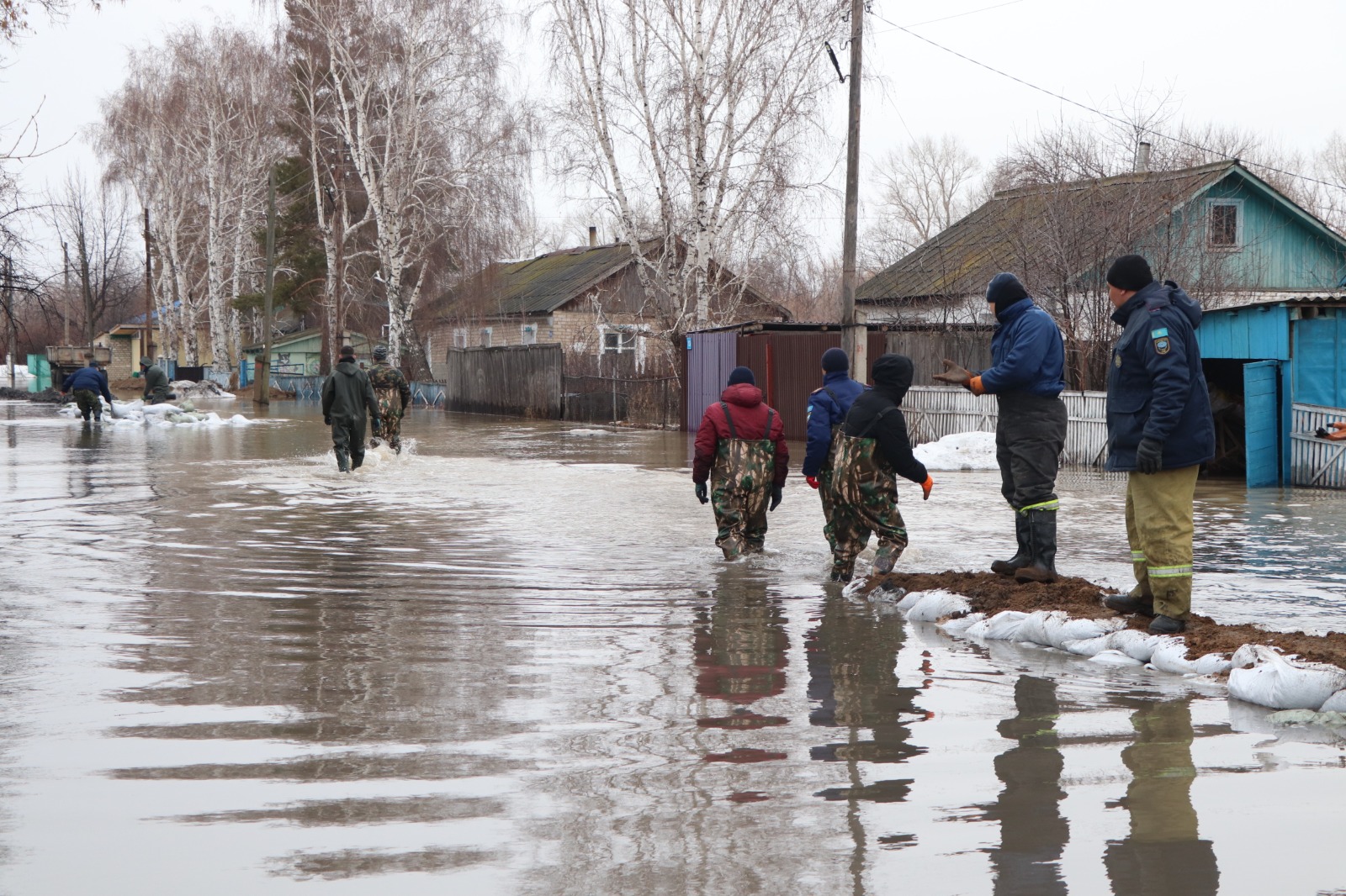 Residents and responders in Kazakhstan reinforce barriers during spring floods.