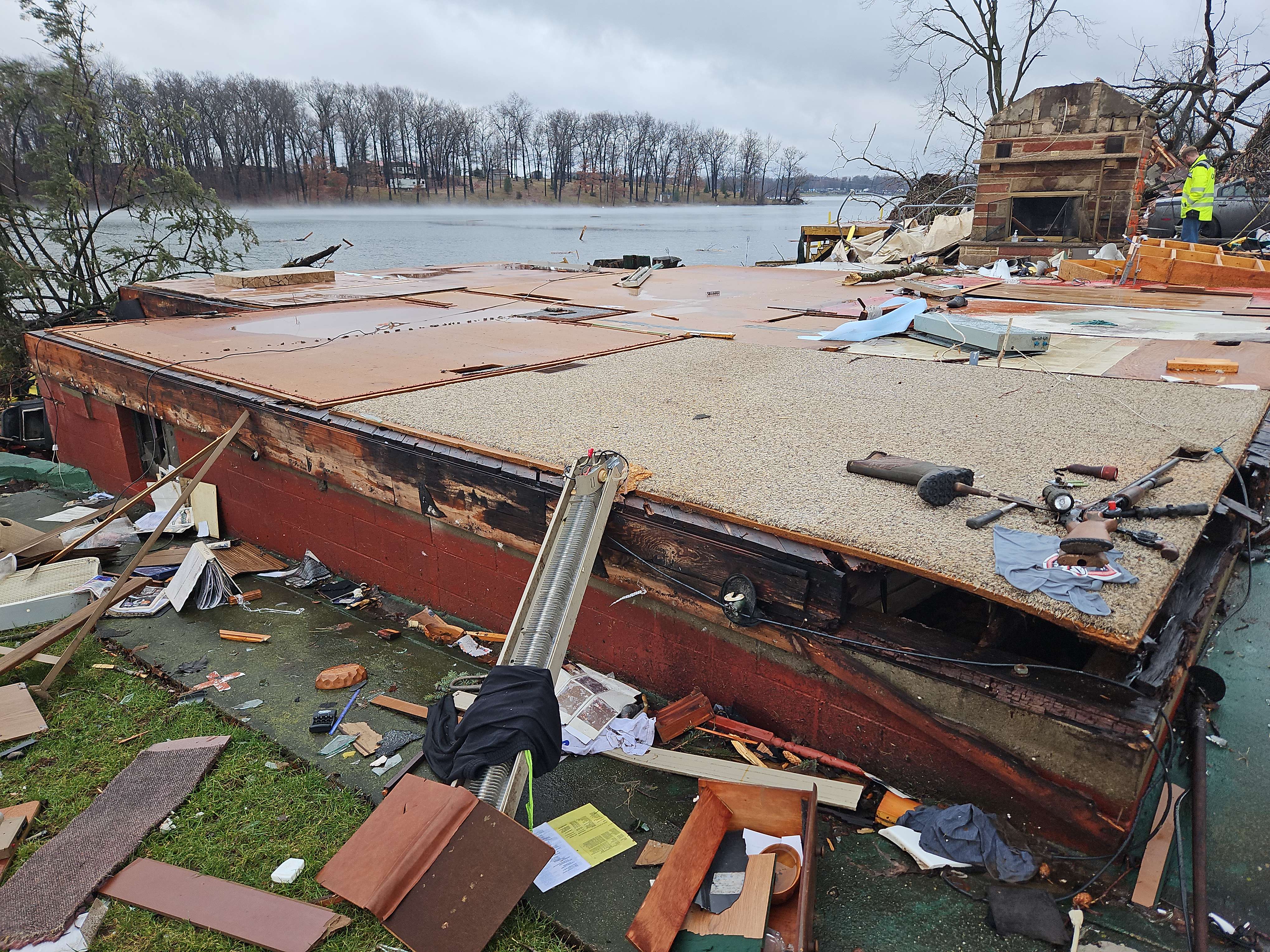 A home that had all of its walls collapse at mid-range EF3 intensity. One man would survive the tornado in the fireplace seen in the background.
