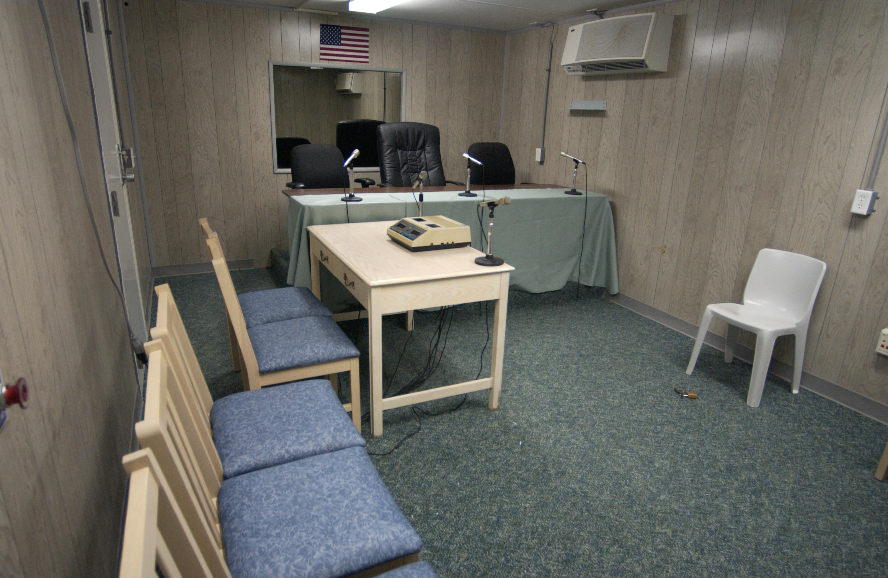 Combatant Status Review Tribunals were held in a trailer the size of a large RV. The captive sat on a plastic garden chair, with his hands and feet shackled to a bolt in the floor. Three chairs were reserved for members of the press, but only 37 of the 574 Tribunals were observed.