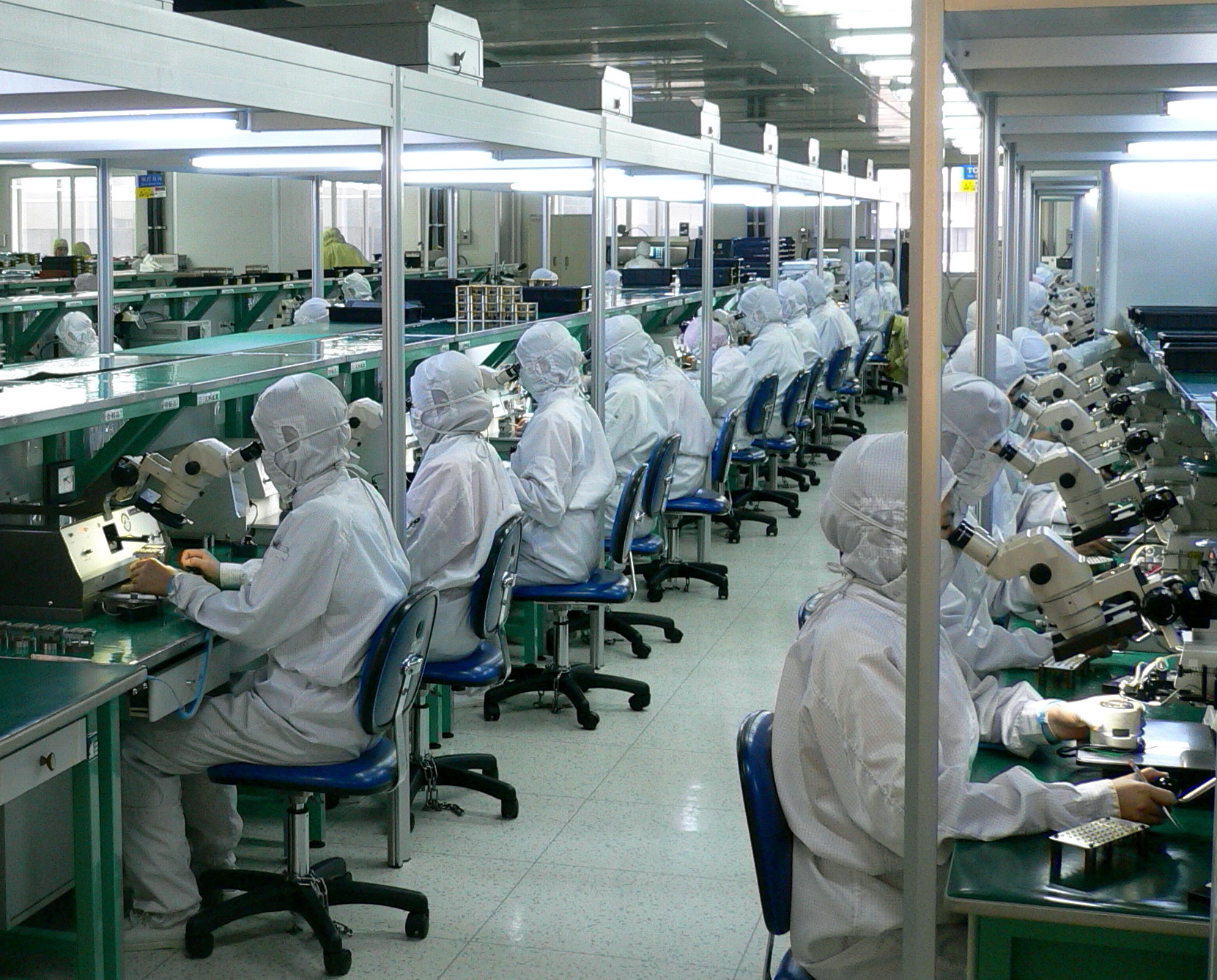 "Thousands of workers in this factory assembling and testing fiber optic systems. In many places of the Chinese economy, human labor replaces automation (in contrast to Japan, for example). "