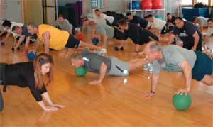Eric Kaniut (in yellow) works out with other officers at Camp Whidbey.