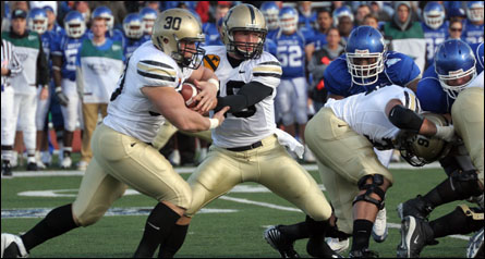 Chip Bowden (#10) conducts a hand-off with fullback Collin Mooney (#30) against Buffalo.