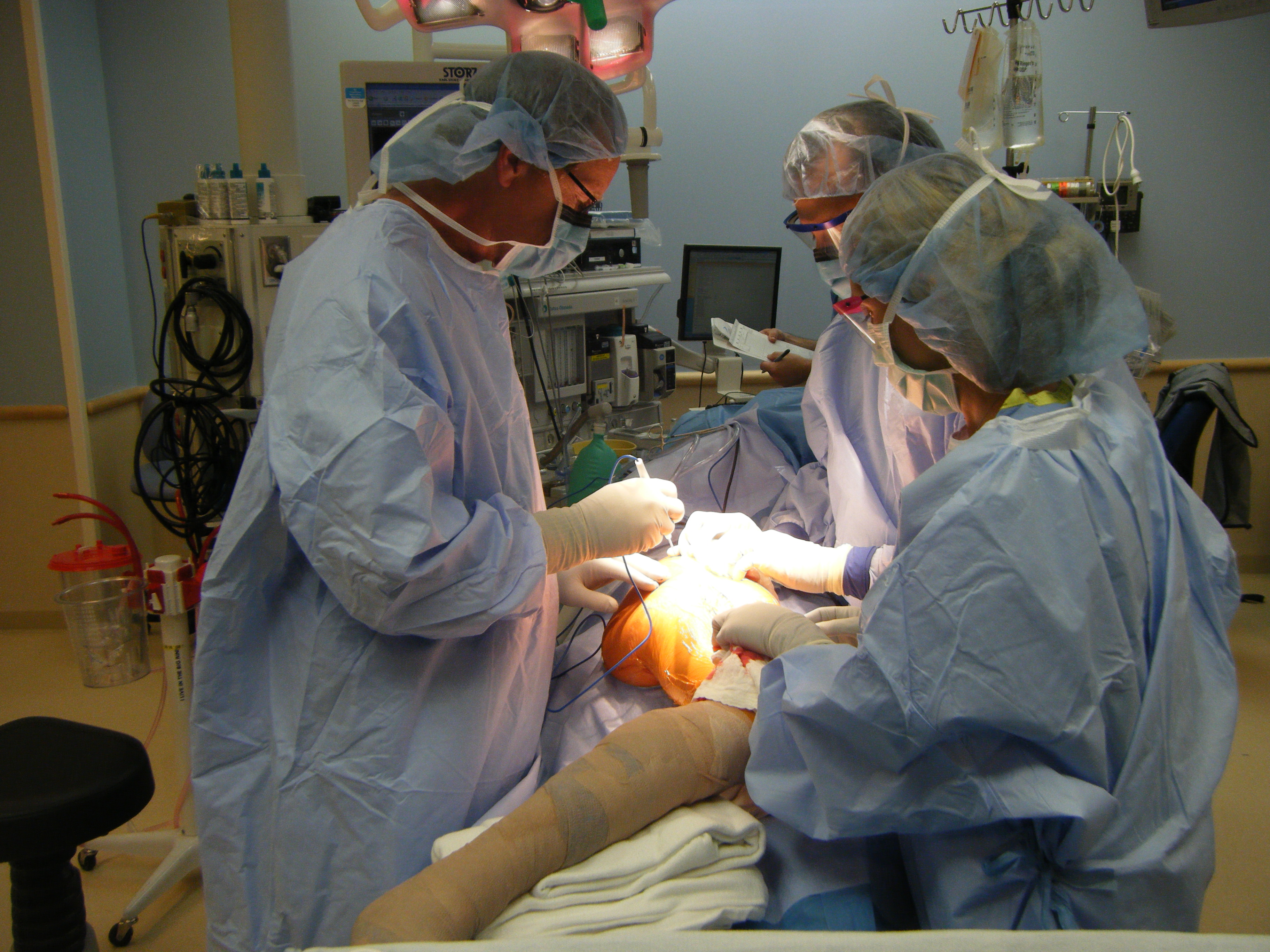 An orthopedic surgeon and assistants performing a limb salvage operation at the Children's Hospital, Aurora, Colorado, USA.