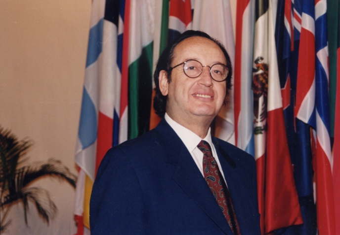 Andre Barsony in front of OECD countries' flags at OECD headquarters in Paris 1988 when he was appointed director
