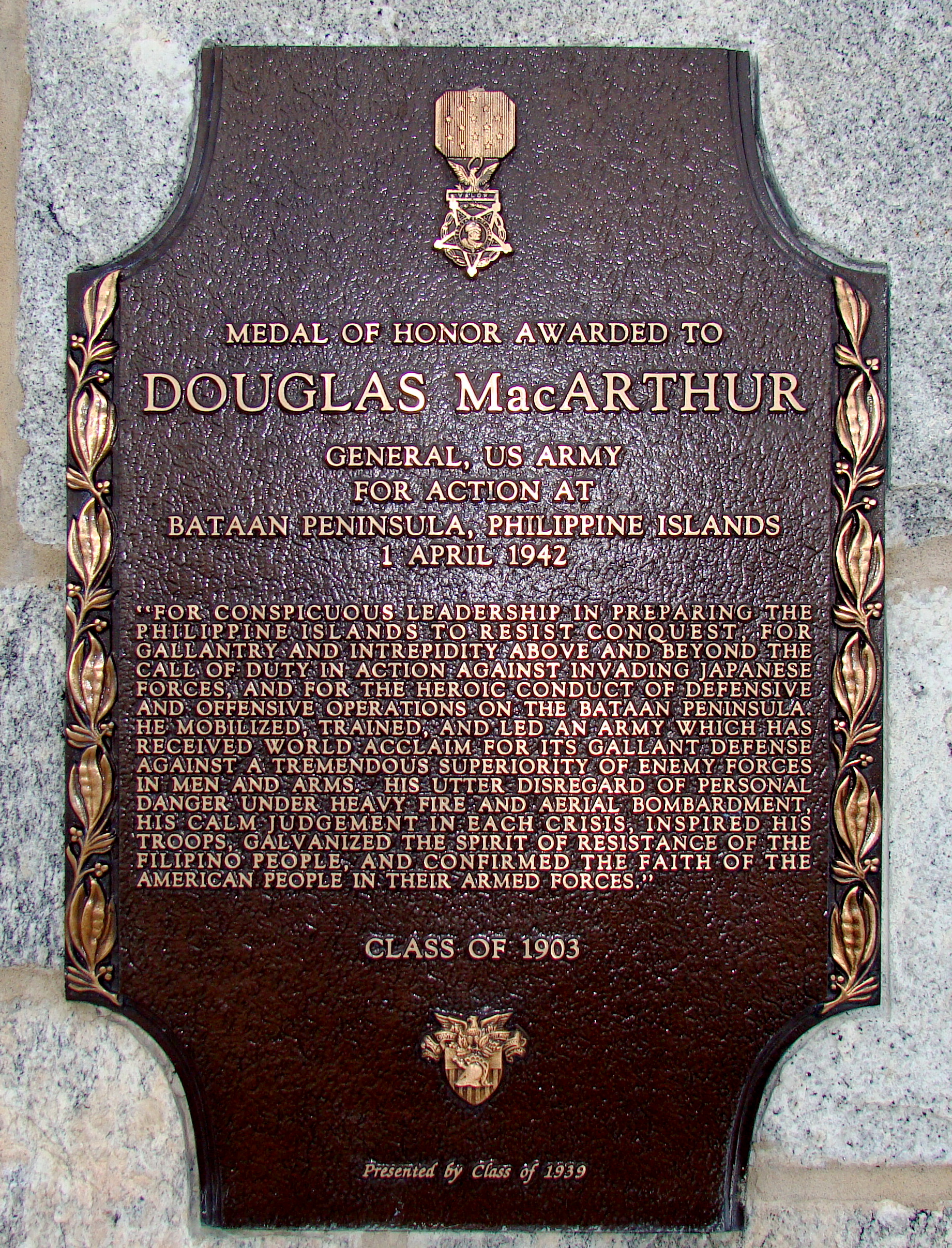 MacArthur's Medal of Honor plaque affixed to MacArthur barracks, USMA|alt=A bronze plaque with an image of the Medal of Honor, inscribed with MacArthur's Medal of Honor citation.