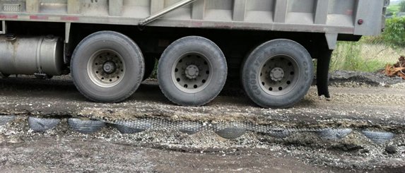 A road built with a base of Mechanical Concrete supports a heavy load.