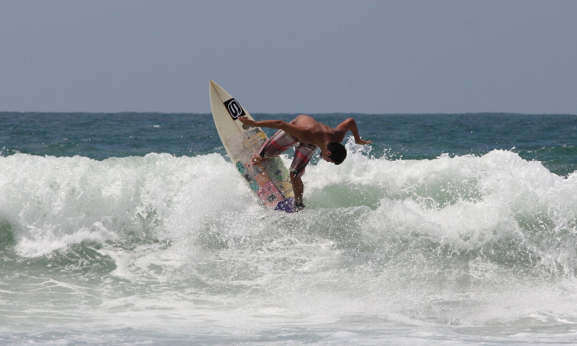A surfer performing a manoeuver with the tip of the board up, in Punta Carnero Ecuador, South America.