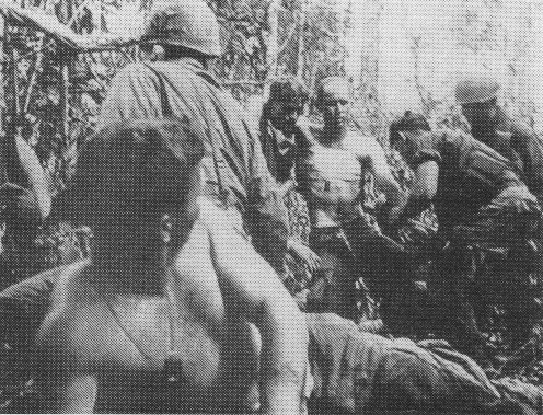ALT=Black and White photo of wounded men|U.S. wounded being moved to aid station during Battle of Dak To