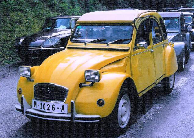 A Citroën 2CV 007, similar to the one used in the film.|alt=A yellow car drives down a grassy road.