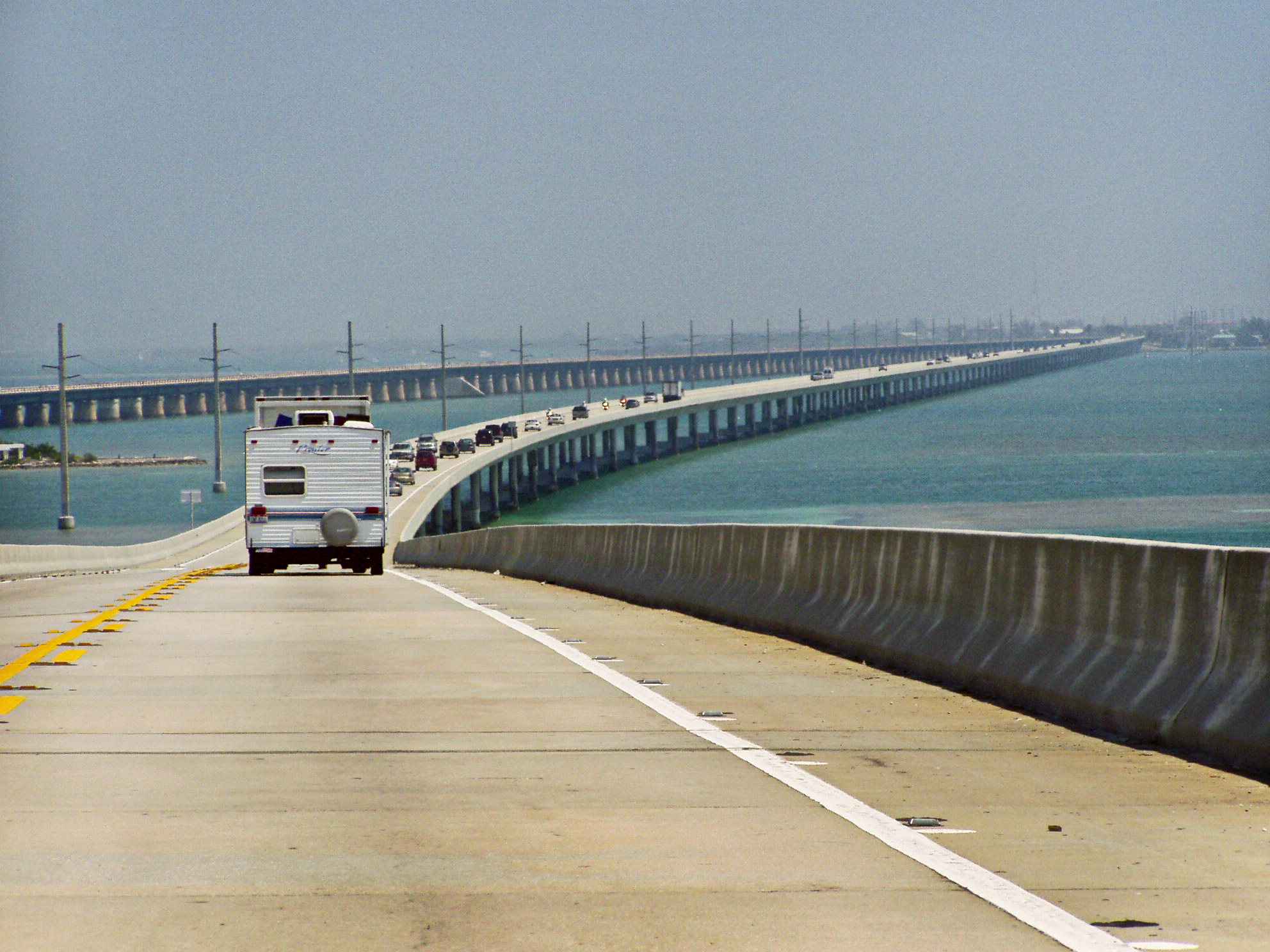 Seven Mile Bridge|alt=A view of a long bridge over water: a number of cars are visible in the left hand lane