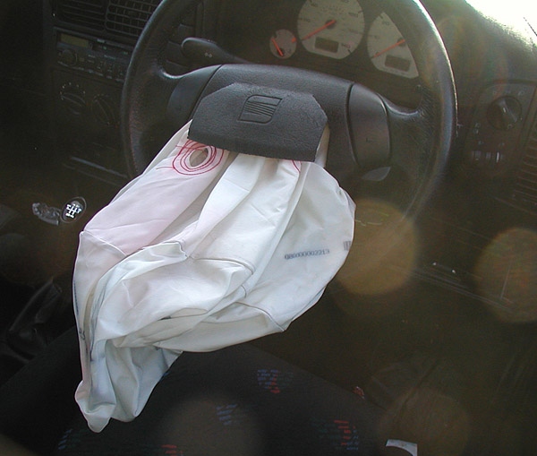 A deflated airbag on a steering wheel after a traffic accident
