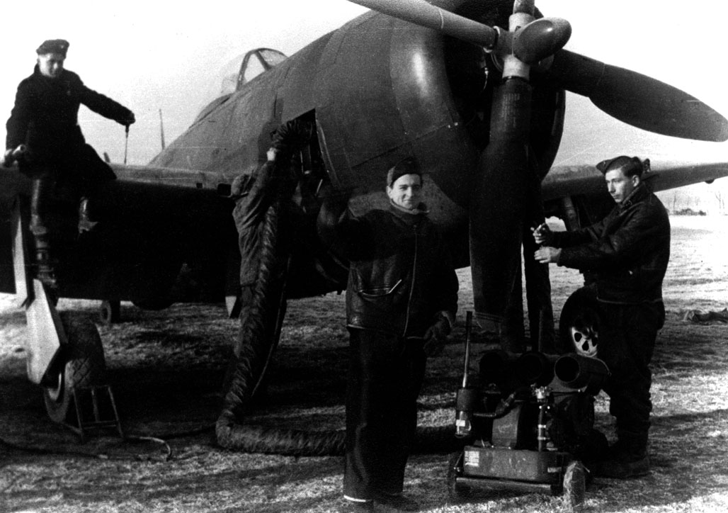 Mechanics preparing a P-47 for the front
