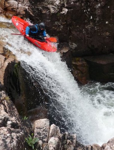 A member of the club paddling 'right angle' on the river Etive