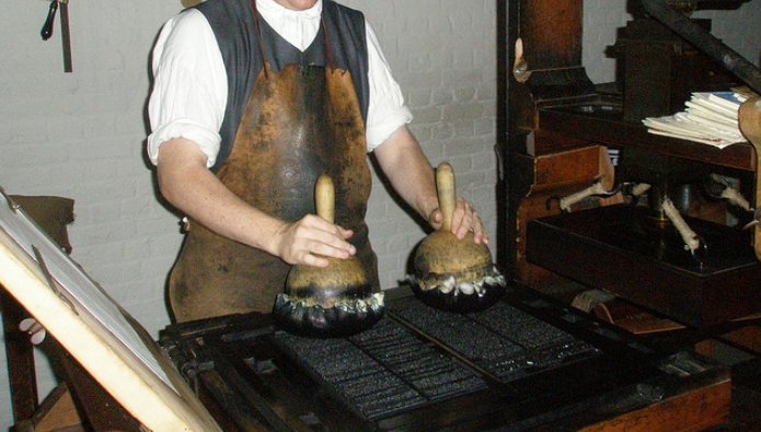 A "beater" inking the printing press