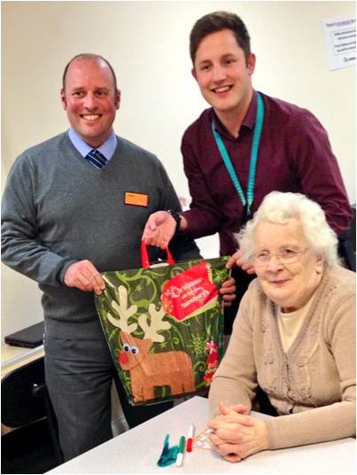 Kevin Nicholson hands out Christmas hampers to Firthmoor over 50's members with Sainsburys Darlington store manager James Dale