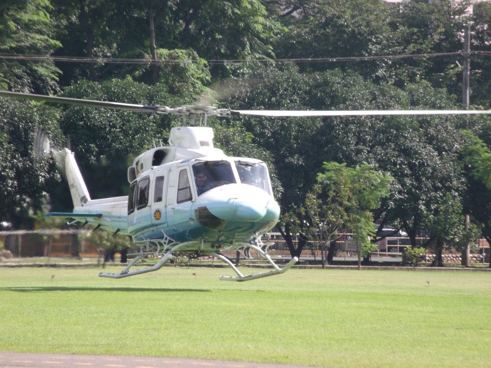 A Bell 412 VIP Transport carrying DND Secretary Voltaire Gazmin lands on an open field near the GHQ Grandstand at Camp Aguinaldo.