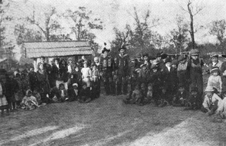 Keetoowah Nighthawk Society leaders Redbird Smith and Bluford Sixkiller instructing children in Cherokee rituals, 1921