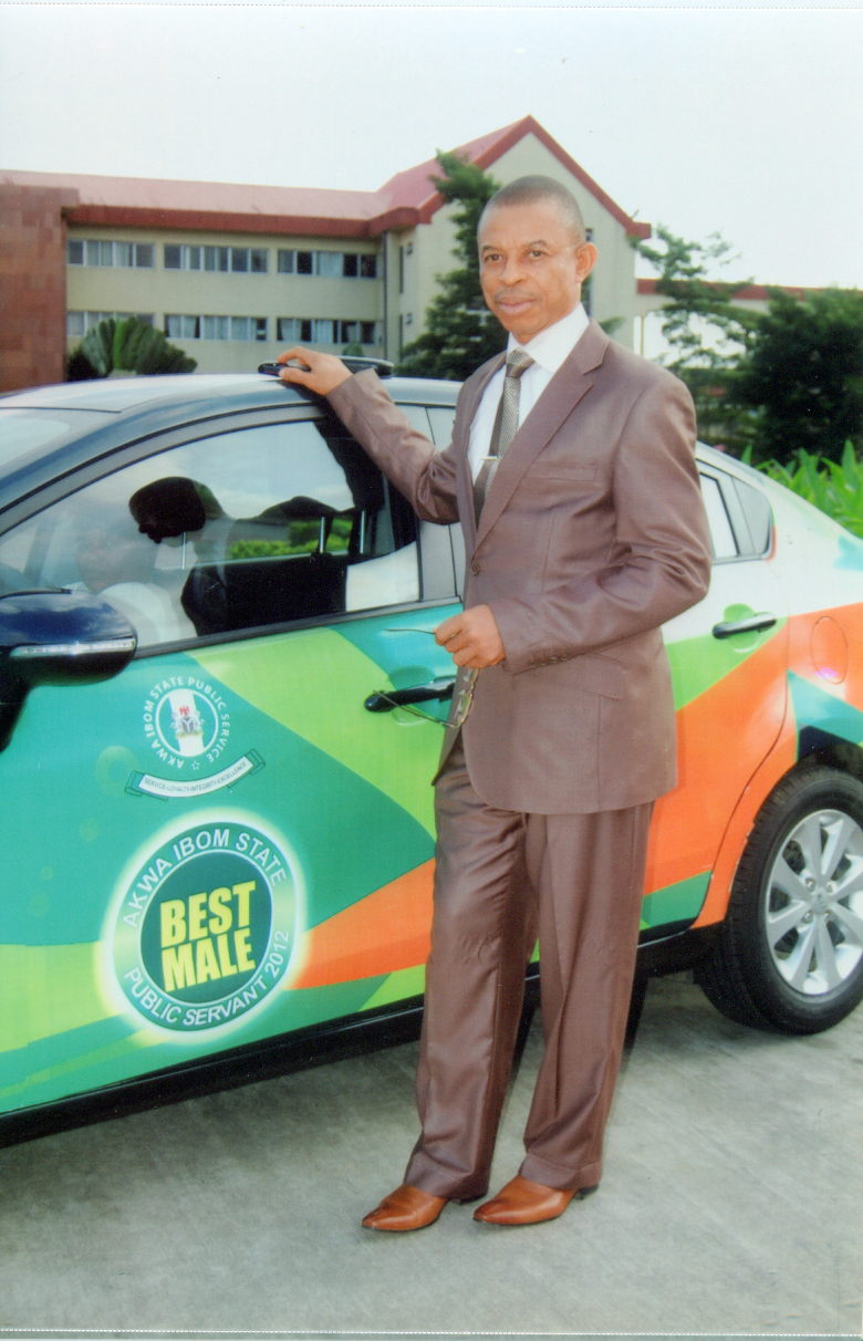 Dr. Ekong Jimmy Effiong stands beside the brand new Kia Rio (2012 model) presented to him as the Best Public Servant, Akwa Ibom state, 2012.