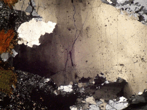 Undulose extinction of fractured quartz affected by plastic deformation.