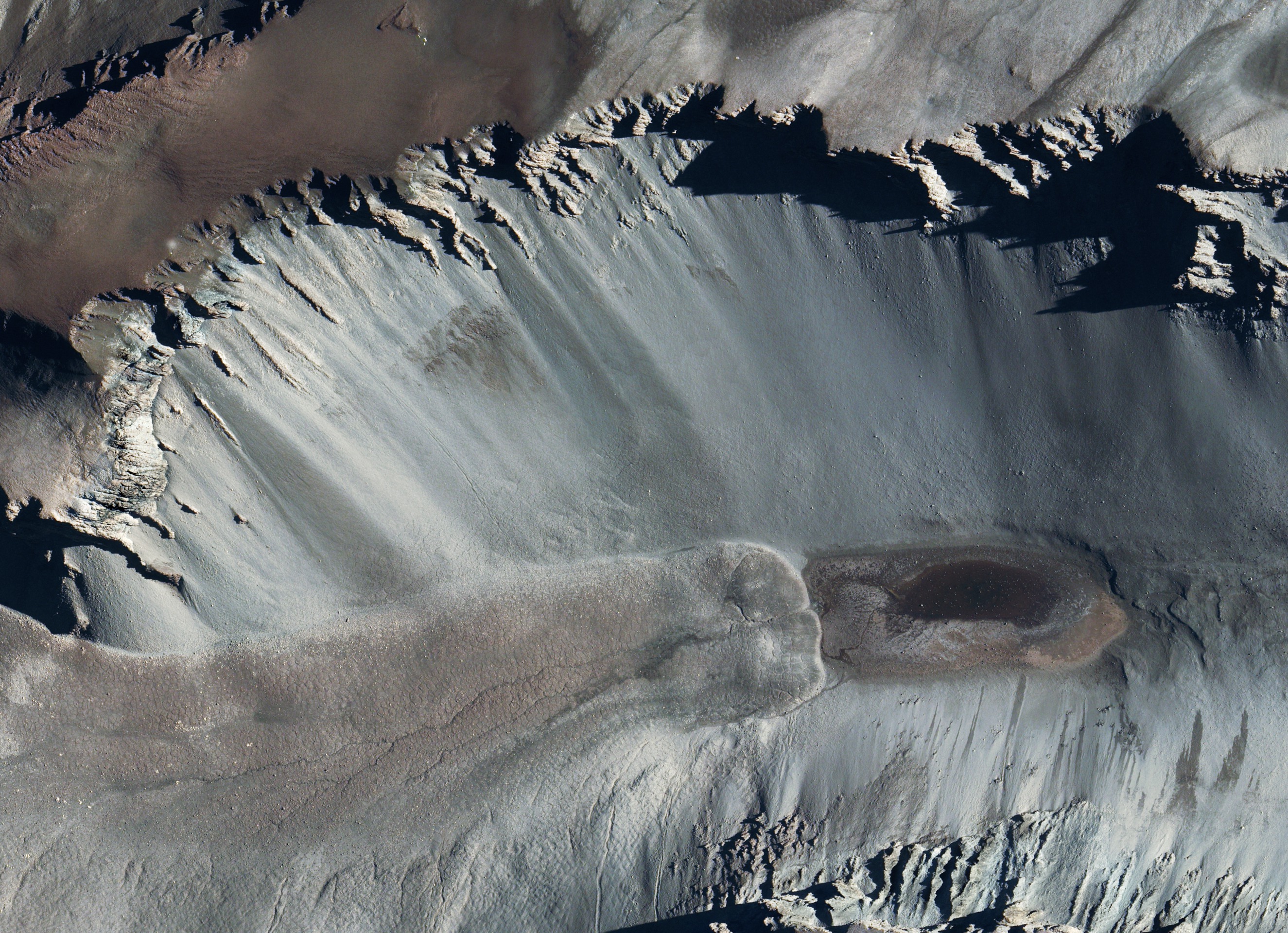 400 px|The tiny Don Juan pond in Antarctica, 100 meters by 300 meters, and 10 cm deep. This pond is about as salty as it could possibly be, with the CaCl2 levels approaching saturation at 60% w/v. It is so salty it stays liquid all the year round, at temperatures ranging from 0°C to -40°C. It has a eutectic of -51.8°C so is believed to be liquid all the year round. The water activity level measured is an exceptionally low 0.3 - 0.6. Though the temperature range is fine for life, it may be too salty for life to reproduce there. Microbes have been found, but they could only grow in less salty conditions. It might be that microbes sometimes can grow there when the water activity level is occasionally raised through influxes of water, and then die. Or they might be washed in from the surroundings.  So far there is no evidence that microbes can actually grow there. It might be the only natural body of water on the Earth of any size without indigenous life. It is of great interest to scientists studying the water activity limits of habitability for astrobiology.