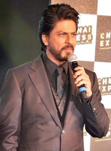 Khan at a promotional event for Chennai Express in 2013|alt=Shah Rukh Khan posing outside at a film festival