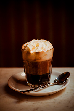 Einspänner, a strong black coffee (often espresso) topped with a thick layer of whipped cream