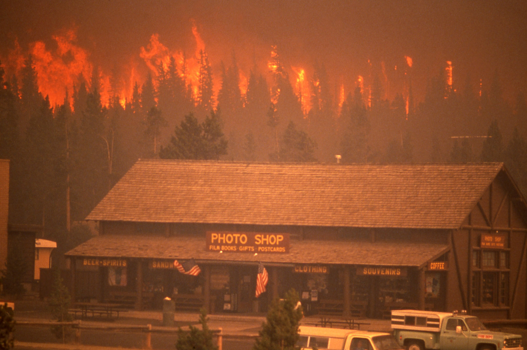A crown fire approaches the Old Faithful complex during the 1988 Yellowstone fires, September 7, 1988.