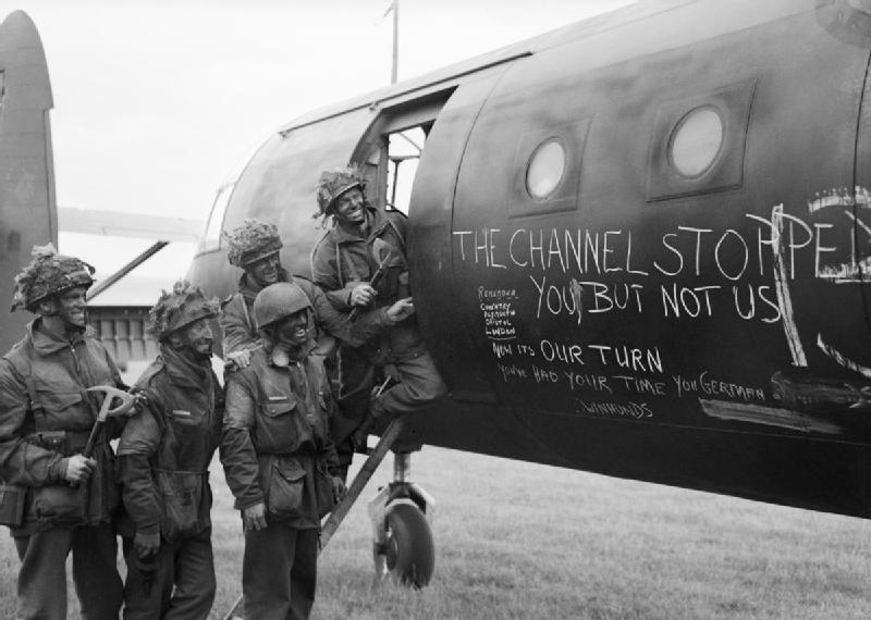 Airborne troops admire the graffiti chalked on the side of their glider as they prepare to fly out as part of the second drop on the night of 6th June 1944 Airborne troops admire the graffiti chalked on the side of their glider as they prepare to fly out as part of the second drop on the night of 6th June 1944