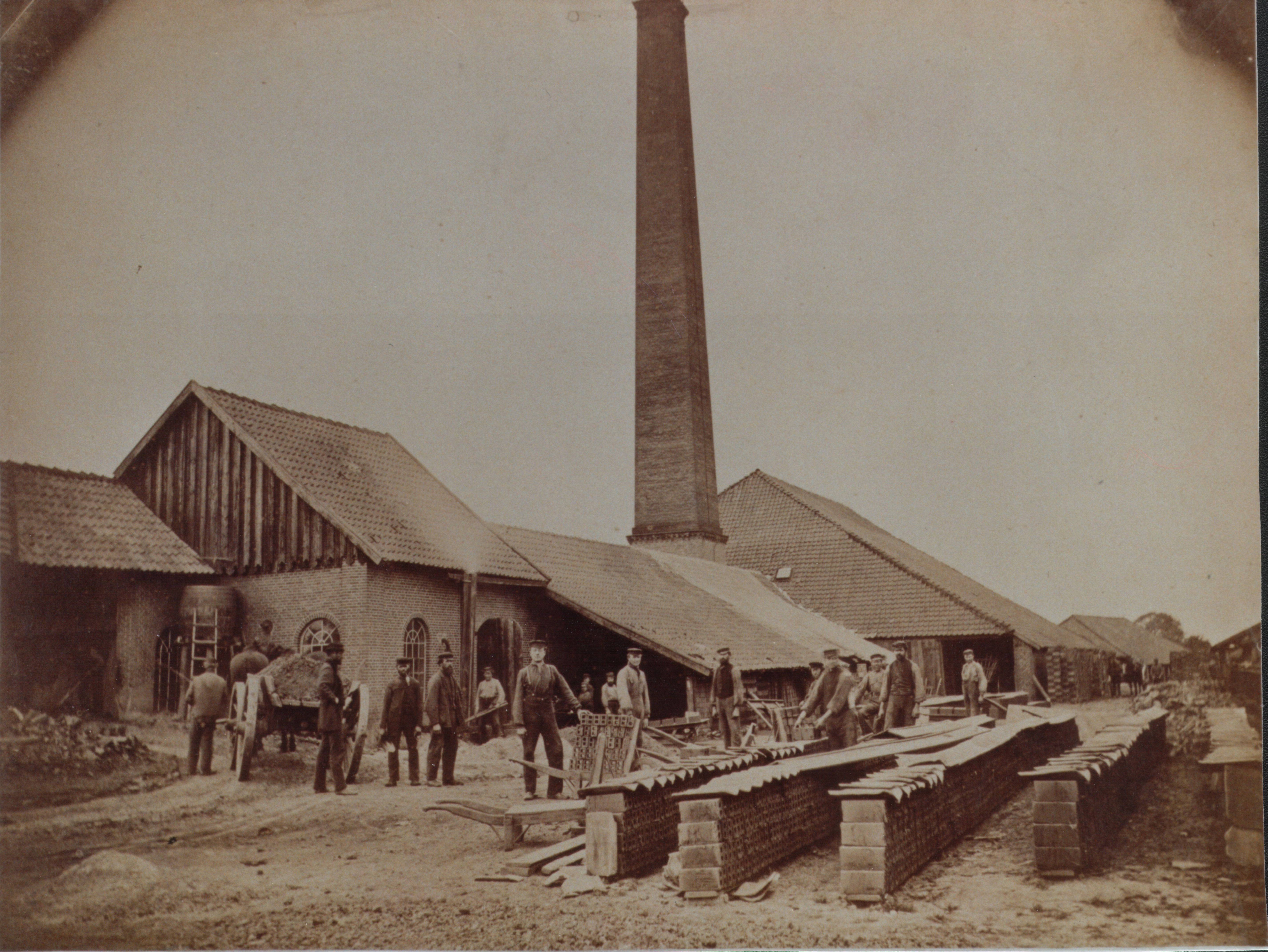 Men working in the yard of a brickworks in Germany, the tall chimney of the kiln visible, 1890 Men working in the yard of a brickworks in Germany, the tall chimney of the kiln visible, 1890