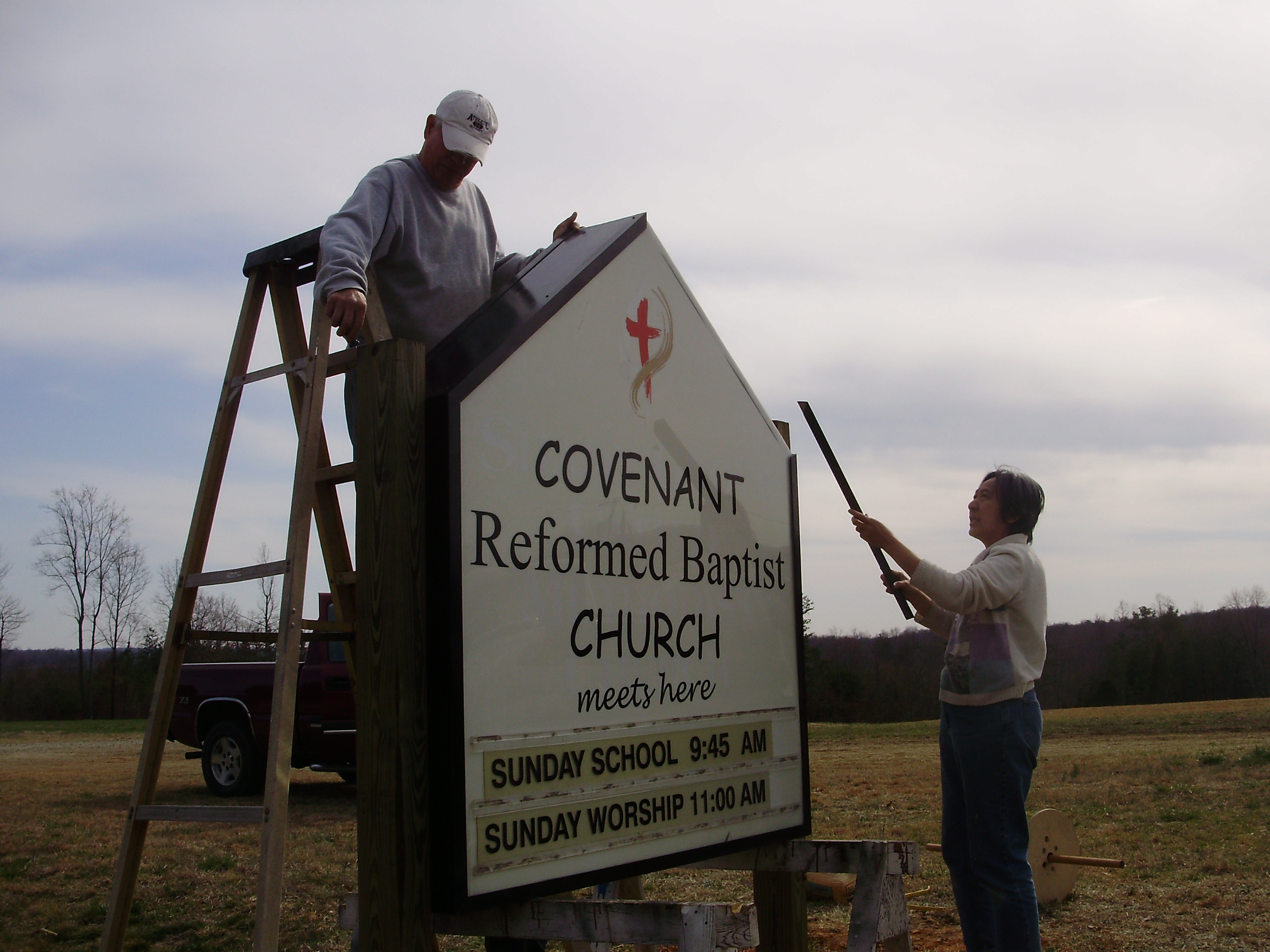 George_Barker_&_Mary_Carpenter_put_up_new_sign_on_Old_86_in_Providence.JPG