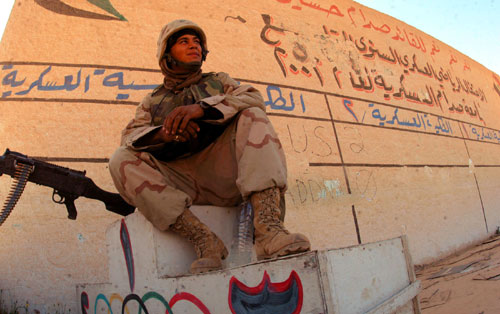 IRAQ -- Lance Cpl. John A. Marcogliese of Marine Air Support Squadron 3 stands guard at one of several Olympic stadiums in Baghdad. By Sgt. Joseph R Chenelly
