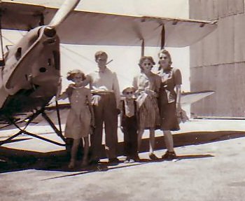 Sandy with his family next to a Tiger Moth two seater planes used for Dessert pipeline supply trips